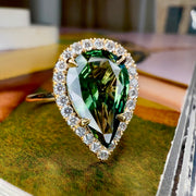Lennox 3.04 carat green sapphire engagement ring in pear shape with diamond halo in 14k yellow gold and thin band with conflict free diamonds, recycled metals and responsibly sourced sapphire by Dana Walden Bridal NYC