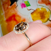 Natural Champagne Diamond Engagement Ring in Yellow Gold with a delicate diamond halo shown on the finger