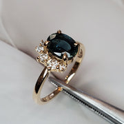 Teal sapphire engagement ring with diamond demi halo set in yellow gold. One of a kind. DANA WALDEN BRIDAL.