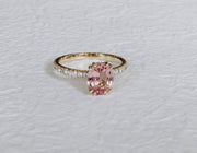 Video of Padparadscha pink sapphire engagement ring set in yellow gold. Made in New York City by Dana Walden Bridal.