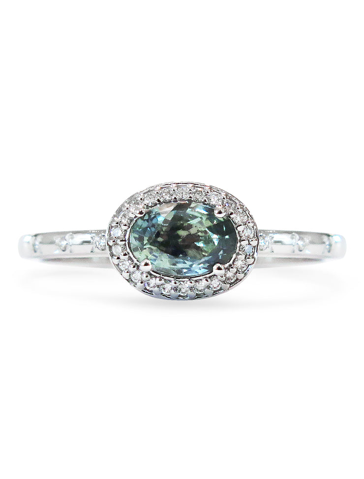 Blue-green sapphire engagement ring with east west diamond halo in white gold, designed by dana walden bridal