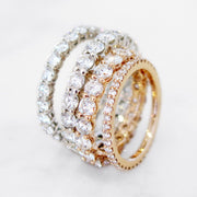 Constance round brilliant diamond eternity bands in varying sizes and metals including rose gold, yellow gold, and white gold. DANA WALDEN BRIDAL.