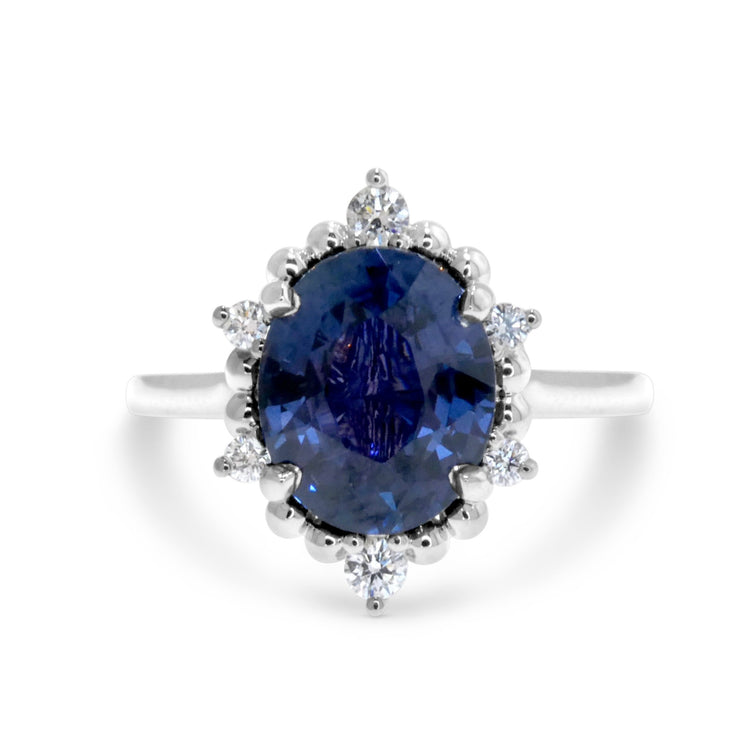 Oval sapphire engagement ring with celestial halo. Handmade by Dana Walden NYC.