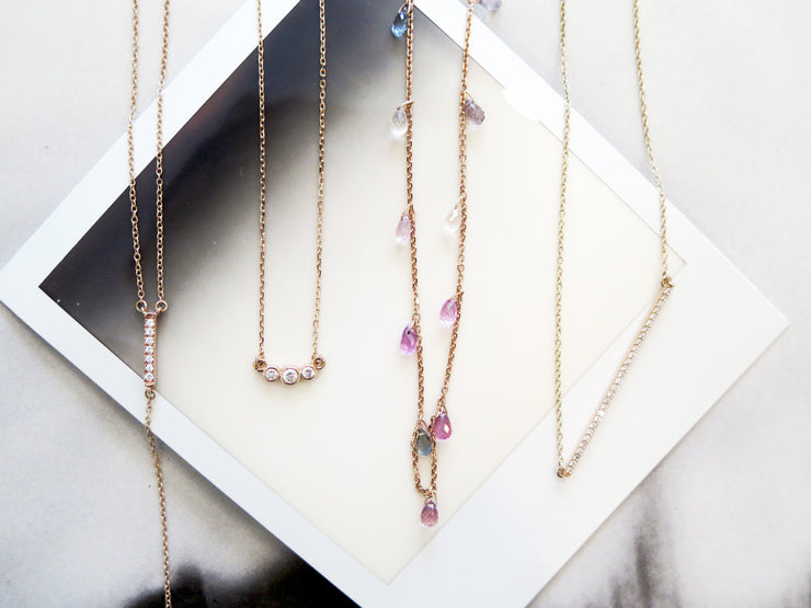 Handmade rose gold and ethical diamond necklace- DANA WALDEN styled with other gold. diamond and sapphire necklaces