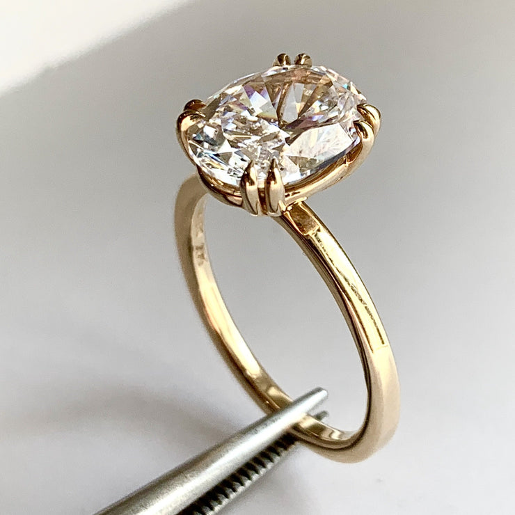 Oval diamond engagement ring, yellow gold solitaire, low profile & delicate, on hand, 2 carat diamond