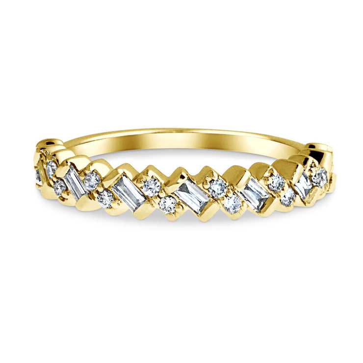 Wedding ring with diagonally set baguette diamonds and round diamonds set in yellow gold. DANA WALDEN BRIDAL.