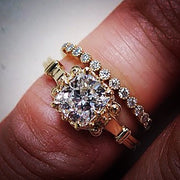 Unique cushion cut diamond engagement ring with wedding band in yellow gold on hand 