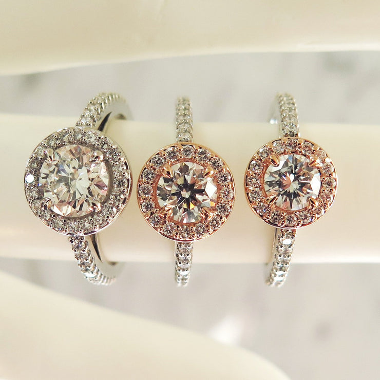 A trio of rose gold and platinum halo engagement rings 