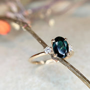 Unique, handmade teal sapphire engagement ring, made with conflict-free gemstones by Dana Walden Bridal in New York City.