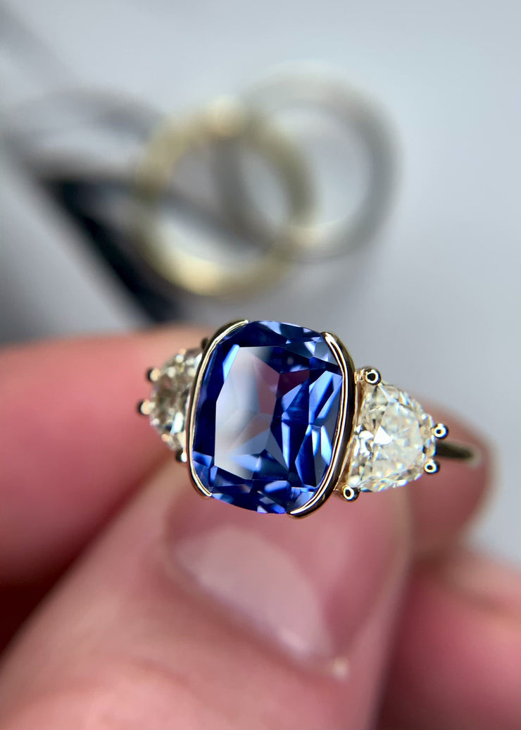 A video of lab-grown sapphire engagement ring with natural lunette diamond accents- DANA WALDEN NYC.