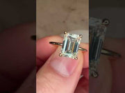 Video of Silas lab grown 1.57 carat emerald cut engagement ring with hidden halo and thin dainty band in recycled 14k yellow gold
