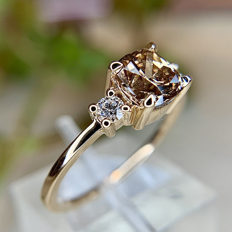 1 carat cushion champagne diamond three stone engagement ring with low profile and thin band in yellow gold by Dana Walden Bridal NYC