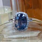 Unique engagement rings- Blue-gray sapphire engagement ring with conflict-free diamond halo.