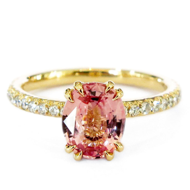 Padparadscha pink sapphire engagement ring set in yellow gold. Made in New York City by Dana Walden Bridal.