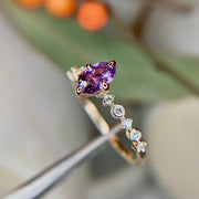 Unique purple sapphire engagement ring with ultra thin diamond accent band in yellow gold by Dana Walden Bridal NYC
