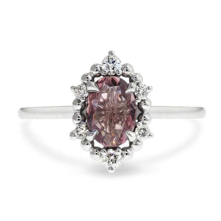Purple sapphire engagement ring with metal bead and diamond halo in white gold.