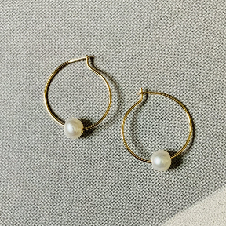 Dainty gold-and-pearl hoops, handmade by Dana Walden Jewelry