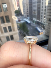 Side View On the finger - Jessa Delicate 2 Carat Lab Grown Oval Diamond Engagement Ring with Hidden Halo in Yellow Gold with double claw prongs - Designed for a wedding band to sit flush NYC 