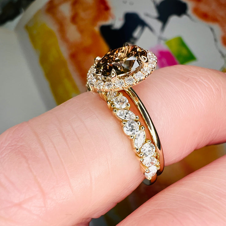 Natural Champagne Diamond Engagement Ring in Yellow Gold with a delicate diamond halo shown with a marquee and round diamond wedding band on the finger
