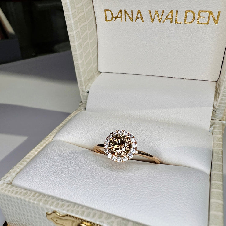 Champagne Diamond Engagement Ring.  Round center diamond with natural white diamond halo accent. Made in eco-friendly yellow gold shown in the ring box