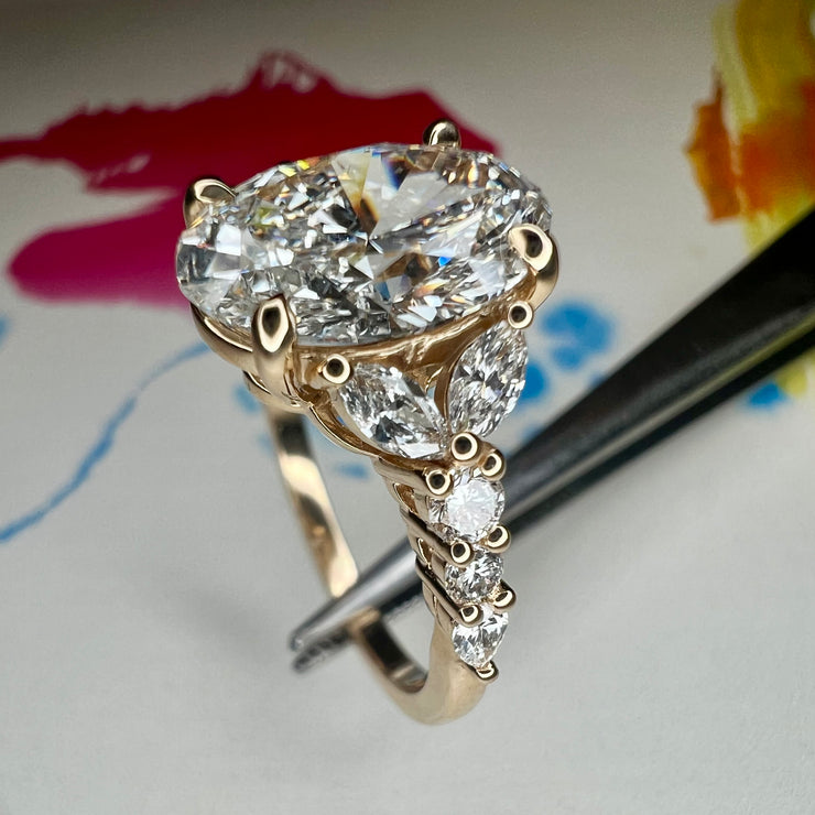 Side View of Unique Oval Lab Grown Diamond Engagement Ring With Marquee And Pear Shape Diamonds Accents in Yellow Gold
