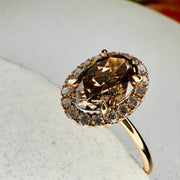 Natural Champagne Diamond Engagement Ring in Yellow Gold with a delicate diamond halo.  Close up view of the claw prongs on the diamond.