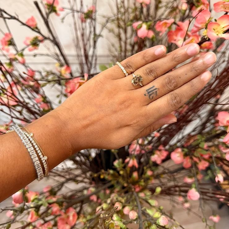 Natural 2.33 carat oval champagne diamond engagement ring with white diamond accents on the hand in 14k yellow gold, custom made by Dana Walden Bridal in NYC
