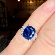 Unique Sapphire Alexandra lab sapphire engagement ring with half-moon, lunette diamonds shown on the hand. DANA WALDEN BRIDAL.