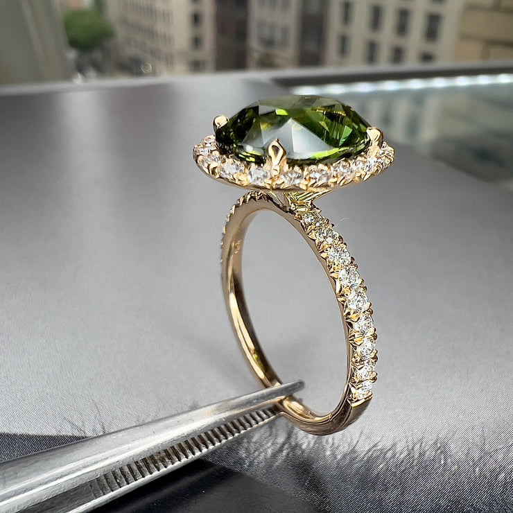 Three Quarters View of Wrenley 5.01 Carat Natural Oval-Cut Green Sapphire Halo Engagement Ring Eco-Friendly 14k Yellow Gold