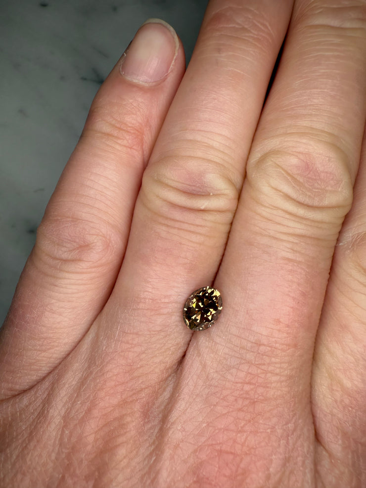 Unique natural 1.42 Carat Old Mine Cut Oval Cushion Cut Champagne Diamond shown on hand for proportion 