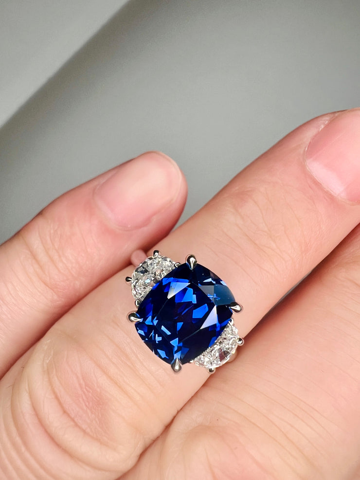 Unique Sapphire Alexandra lab sapphire engagement ring with half-moon, lunette diamonds shown on the finger DANA WALDEN BRIDAL. 
