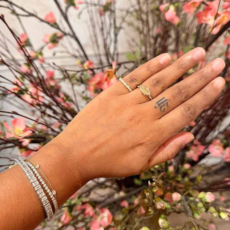 Natural marquise champagne diamond east west engagement ring in yellow gold shown on hand with white diamond pave and delicate setting handmade in NYC by custom jewelry designers, Dana Walden Chin and Radika Chin 