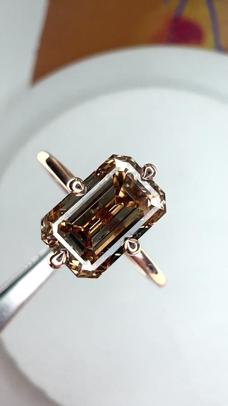 Video of Sofia champagne diamond with hidden halo in emerald cut and 14k rose gold thin band