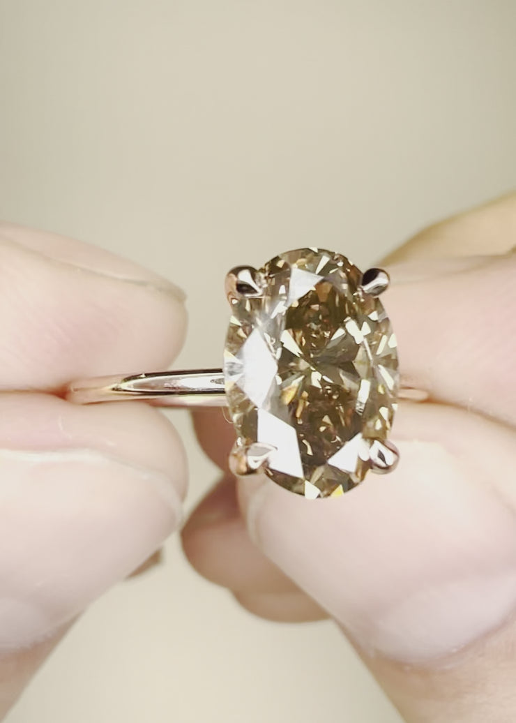 Video of Alessia champagne diamond engagement ring with oval diamond in 14k rose gold setting with hidden halo and thin band