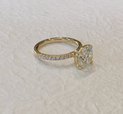 Video of a yellow gold engagement ring with a round brilliant cut ethical diamond and small diamond accents in the band, also known as micro pave. Dana Walden Bridal NYC.