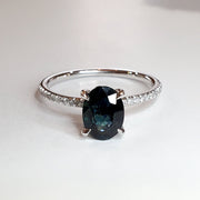 Uma oval teal sapphire engagement ring in 14k white gold with thin micro-pave diamond band 