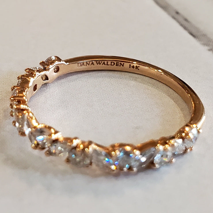 Side profile of diamond wreath wedding ring in 14k rose gold with unique marquise and round diamond in half band style 