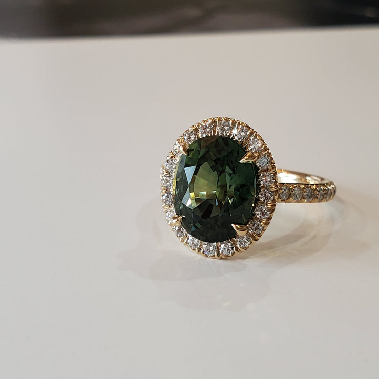 Oval green sapphire engagement ring with seamless halo and micro pave. DANA WALDEN BRIDAL.