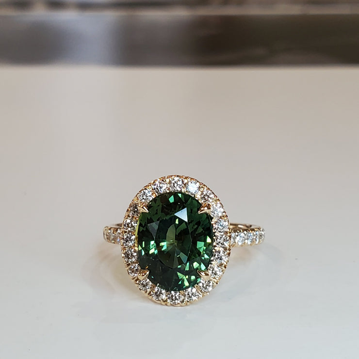 Oval green sapphire engagement ring with seamless halo and micro pave. DANA WALDEN BRIDAL.