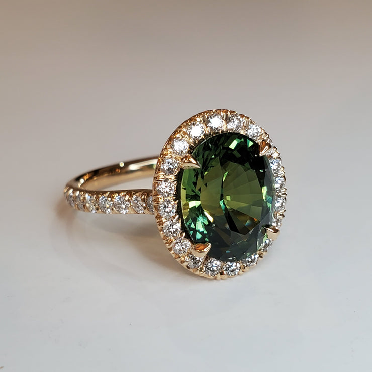 Oval green sapphire engagement ring with seamless halo and micro pave. DANA WALDEN BRIDAL.