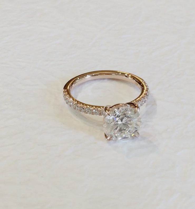 Video of a rose gold diamond engagement ring with small diamond accents in the band. Dana Walden Bridal NYC.