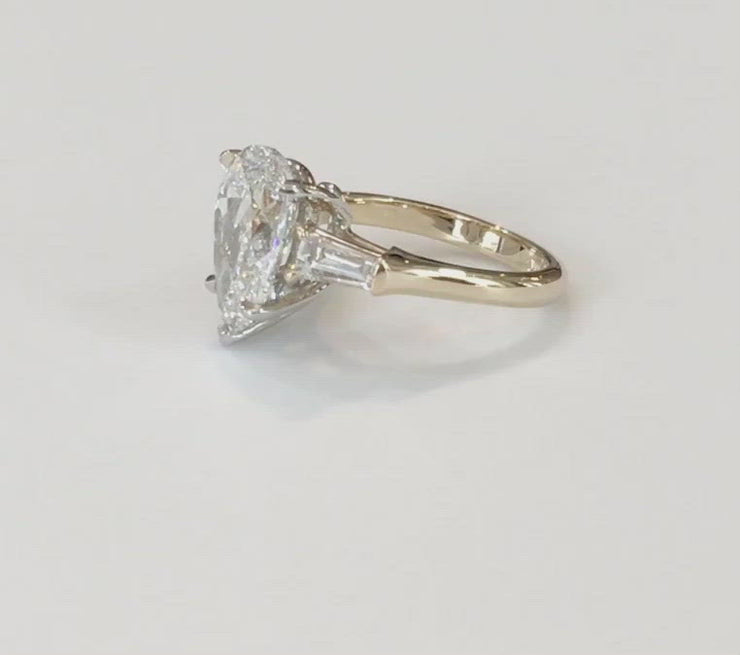 VIDEO OF 2 carat pear shaped engagement ring in yellow gold with baguette accent stones. DANA WLADEN BRIDAL.