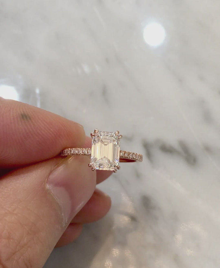 Video of emerald-cut diamond engagement ring set in rose gold. Dana Walden Bridal NYC.