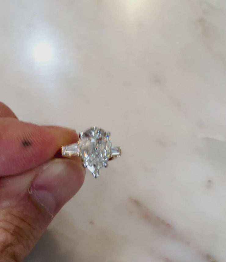 VIDEO 2 carat pear shaped engagement ring in yellow gold with baguette accent stones. DANA WLADEN BRIDAL.