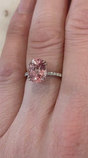 video of Padparadscha pink lab sapphire engagement ring with white diamond accents. DANA WALDEN BRIDAL NYC.