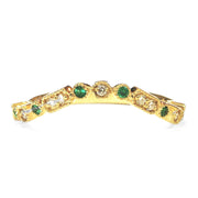 ALTERNATE VIEW- A gently curved emerald and gold wedding ring set in yellow gold. DANA WALDEN BRIDAL NYC.