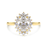 Oval diamond halo engagement ring with tipped prongs in yellow gold. DANA WALDEN NYC.