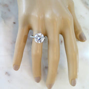 5 carat diamond engagement ring on hand in platinum with diamonds