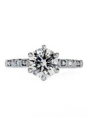 Six prong diamond solitaire engagement ring with a detailed art deco band. Dana Walden Bridal NYC.