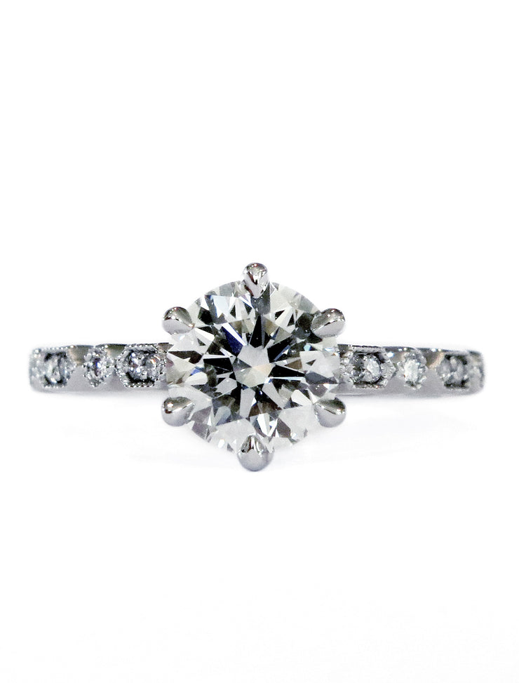 Six prong diamond solitaire engagement ring with a detailed art deco band. Dana Walden Bridal NYC.